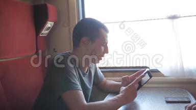 男子旅行者放松在火车上听音乐和微笑通过图片通过社交生活媒体。 慢慢慢慢