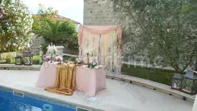 在游泳池附近的婚宴上的一张桌子。 婚礼装饰