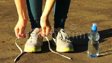 女孩停止跑步，把<strong>鞋</strong>带系在跑<strong>鞋</strong>上。 健身女孩在<strong>户外</strong>训练。 高清120f