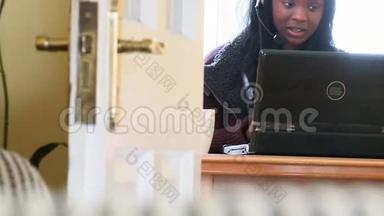 笑的女人用带耳机的笔记本电脑