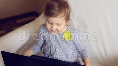 漂亮的女孩坐在笔记本电脑前学习上网。