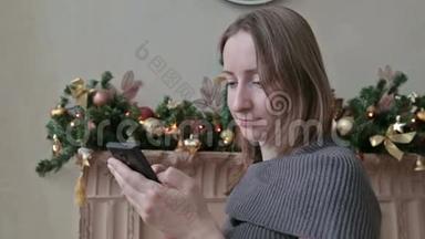 在圣诞<strong>节</strong>，一个女人在家里用<strong>手机</strong>