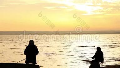 渔民在平静的日落海边