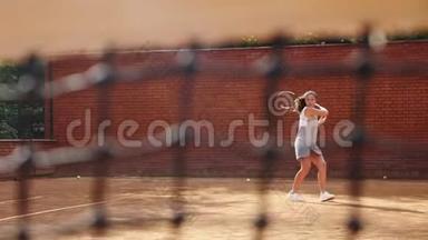 年轻女孩在训练时用网球拍挡住球