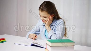 快乐的学校女孩在家读书或<strong>课本</strong>
