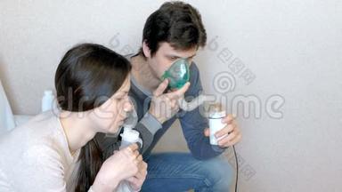 使用雾化器和吸入器进行治疗。 男人和女人通过吸入器面罩吸入。 侧视。