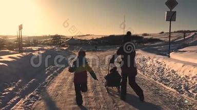 十几岁的<strong>女儿</strong>和母亲拉着小儿子在雪橇上跑。 剪影<strong>一家人</strong>在冬天玩。 积极健康