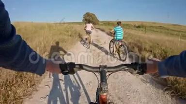 两个孩子和他们的父亲在乡下骑自行车