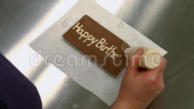工人在巧克力牌匾上写生日快乐