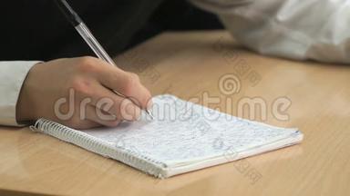 学生用钢笔在练习本上写课文