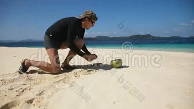 在海滩上喝<strong>椰子汁</strong>的男人