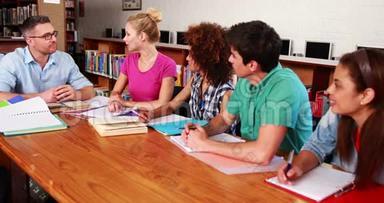 年轻学生和老师一起在图书馆学习