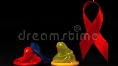 彩色避孕套在红丝带旁边掉落