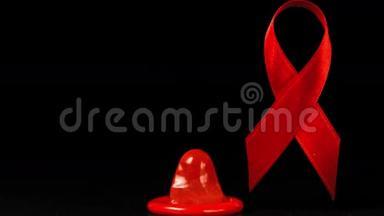 避孕套掉在黑色背景上的红色丝带前面