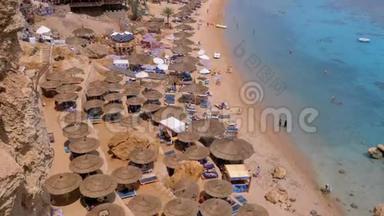 在珊瑚礁红海的豪华酒店，用雨伞、日光浴床和棕榈树观赏珊瑚海滩的全景。 埃及。