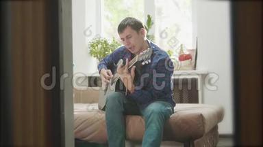 用木吉他演奏音乐的男子吉他手。男子演奏原声吉他近距离慢动作视频。在