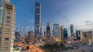 在科威特城市中心，摩天大楼的天际线在黄昏时分被照亮。 中东科威特市