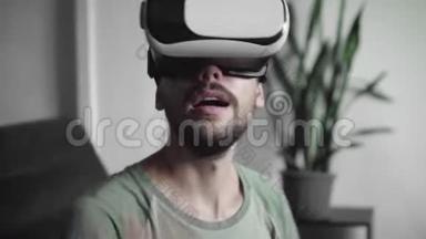 年轻留胡子的嬉皮士用他的VR耳机显示虚拟现实游戏或观看360视频，并试图