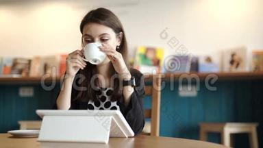女人坐在餐馆的桌子旁。 带着可以<strong>上网</strong>的平板电脑