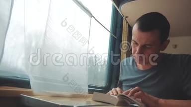 人在火车<strong>长途旅行</strong>中看书.. 铁路<strong>旅行</strong>概念教练火车<strong>旅行</strong>。 从窗户看到美丽的景色