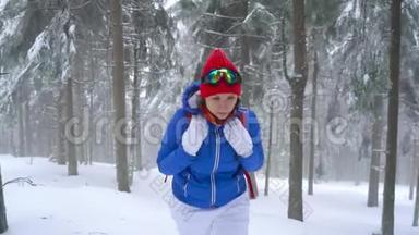 孤独的旅游女孩走在冬天白雪覆盖的针叶林在山上。 霜冻天气