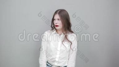 失望的年轻女子穿着时尚的白衬衫，看上去<strong>很困</strong>惑