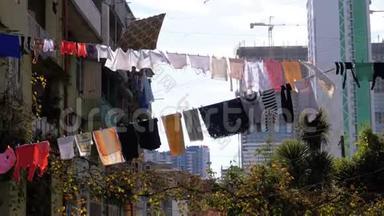 城市贫困地区一栋多层建筑上的一根绳子上挂着和烘干的衣服
