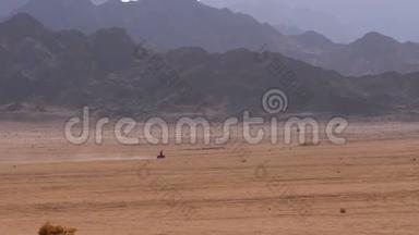 在埃及的沙漠中骑<strong>四方</strong>自行车小组，以山脉为背景。 驾驶ATV。