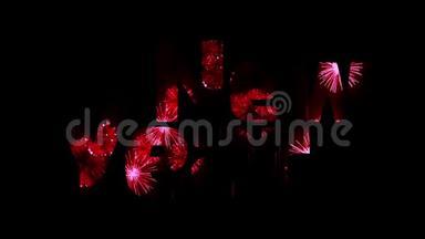 美丽的红色烟花透过文字闪耀新年快乐。 新年庆祝活动的组成。 明亮的烟花