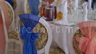 眼镜，盘子，<strong>餐具和餐巾</strong>.. 为聚会装饰了鲜花的桌子。 婚宴，生日
