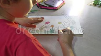 小女孩在桌子上画画。 在室内用油漆铅笔画画的女孩