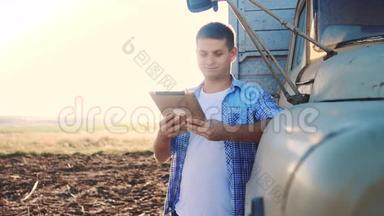 聪明的农业<strong>司机</strong>。 男子农民<strong>司机</strong>站在卡车附近的数字平板电脑。 慢动作视频。 肖像