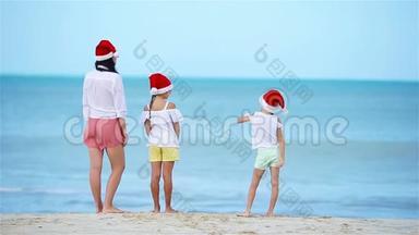 圣诞节假期，一家人在白色海滩戴圣诞帽