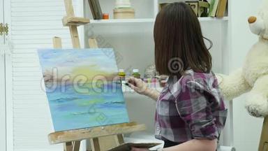 一位年轻女子站在画架后面的一张画布上，在一个大<strong>气车</strong>间里画一幅画