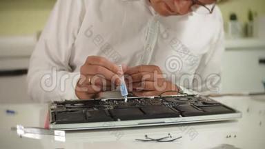 一个人正在修理笔记本电脑。 计算机修复的概念.. 用一个人修理笔记本电脑主板