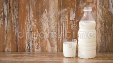 木制桌子上的玻璃和牛奶瓶