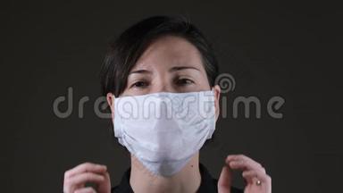 一名高加索妇女摘下一张白色医疗面罩、预防<strong>传染病</strong>、冠状病毒的肖像