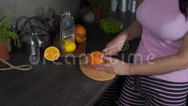 女人在厨房的木板上<strong>切水果</strong>。 女人`砧板上用刀<strong>切</strong>橘子。
