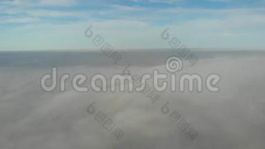 在云层上空飞行。 凌晨无人机拍摄的视频。 城市上空的烟雾。 透过云层看教堂穹顶。 实际