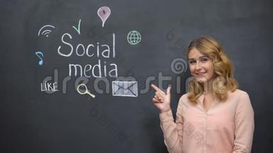 女孩指着黑板上的社交媒体标志，<strong>沉迷</strong>于<strong>网络</strong>