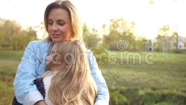 少女在秋天的城市公园拥抱她美丽的年轻<strong>母亲</strong>。 <strong>母亲</strong>和女儿，<strong>母亲</strong>日