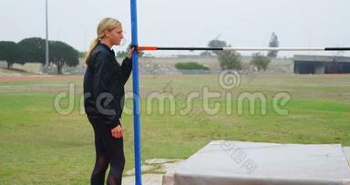 女子运动员在体育场馆4k检查跳高杆