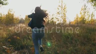 年轻的女人穿过秋天的森林，手里拿着一束黄色的<strong>叶子</strong>，把它们扔掉。 <strong>女士</strong>很开心
