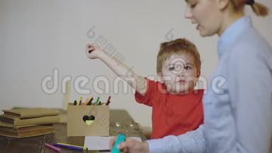 孩子和母亲用彩色铅笔画画。 带着母亲的男孩在白色背景上被隔离。 可爱的男孩