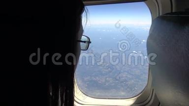 4K亚洲年轻漂亮女孩在飞机<strong>飞行时</strong>从窗户向外看