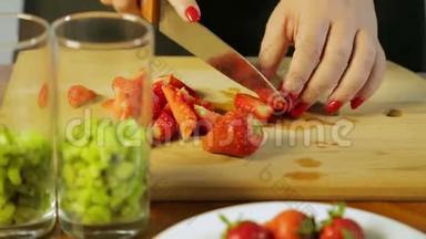 一个女人用<strong>一把</strong>大刀在木板上用<strong>一把</strong>大刀切熟草莓。