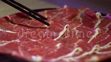 牛肉生肉用筷子缓慢移动. 北京的中国火锅