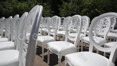 白色椅子和白色和红色鲜花的婚礼装饰靠近海边的花店