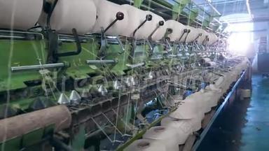 缝织机与筒管缠绕白线。 现代纺织厂。