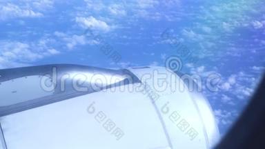 引擎飞机在蓝天的蓬松的云层中飞行。 从飞行飞机到涡轮的蓝天和白色景色